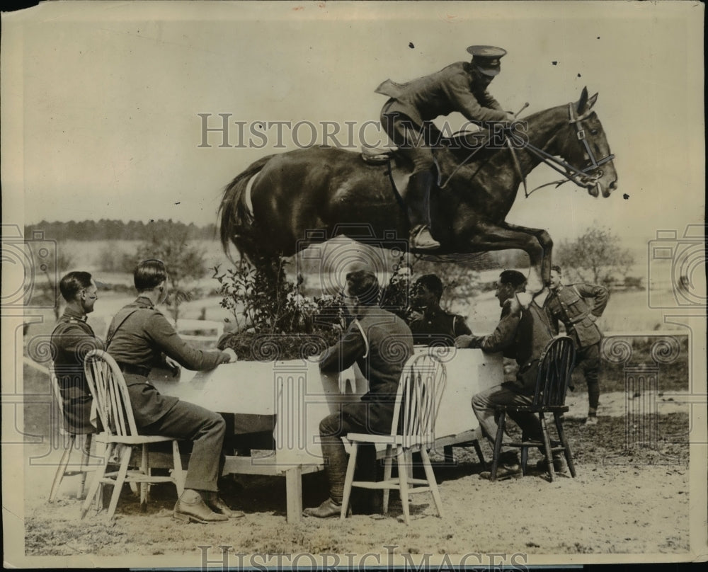 1927 Royal Tournament members of 5th Lancers jumping over dinner - Historic Images