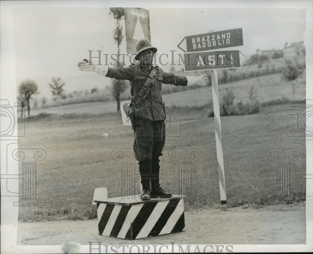 1939 Military Traffic Officer in Asti Directs Traffic of Soldiers - Historic Images