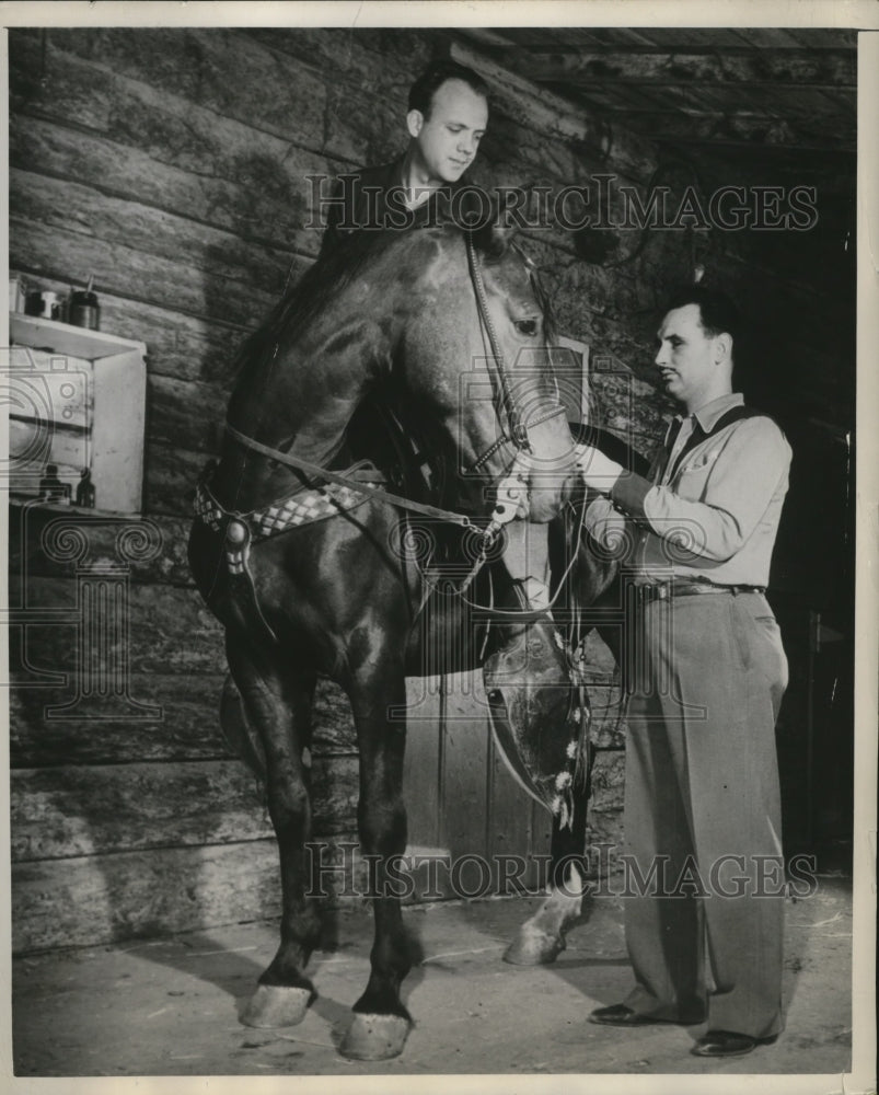 1949 Press Photo Dale Reed Adjusts Harness for Sightless Rider Kenneth Wiley-Historic Images