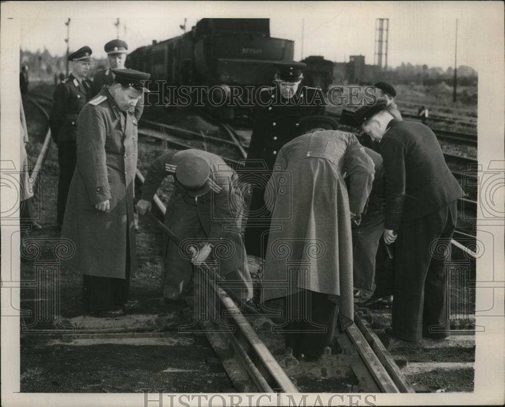 1949 Russian officers try to free jammed rail tangled at Priesterweg - Historic Images