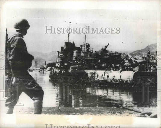 1943 An Italian sentry guards a French ship  the Nazi's salvaged - Historic Images