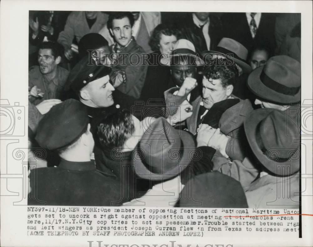 1949 Press Photo NYC cop tries to keep peace at National Maritime Union meeting- Historic Images