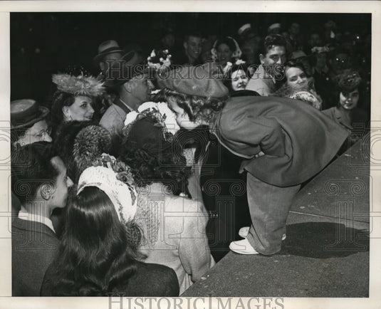1946 New York Beverly A Williams sniffs flowers at St Patrick's NYC - Historic Images