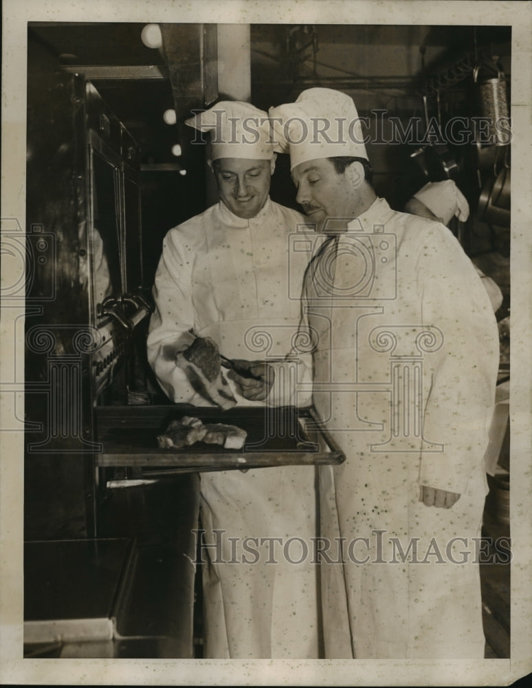 1939 Press Photo Grover Whalen holds a steak in the kitchen - Historic Images