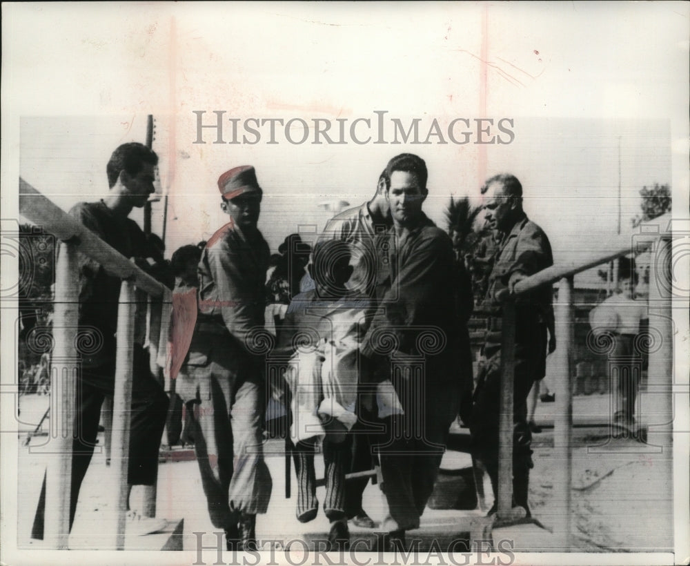 1965 Press Photo 2 Cuban Immigration Officers Carry Elderly Man to Boat to US-Historic Images