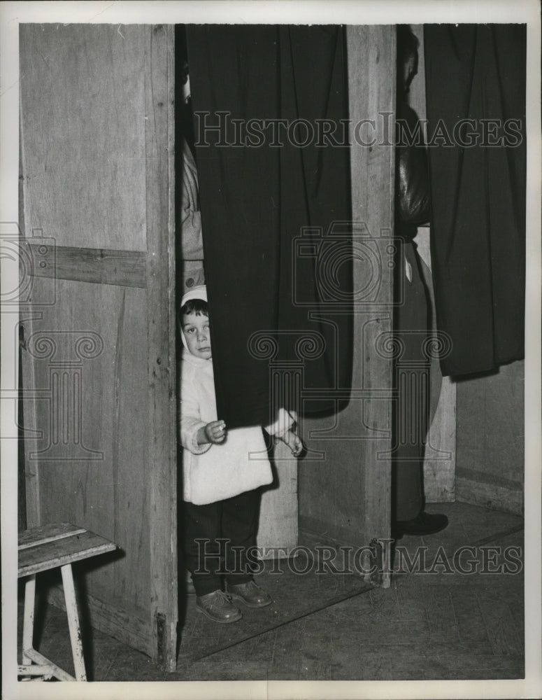 1958 Press Photo Paris- Parisian youngster has fun in a voting booth - nera00537 - Historic Images