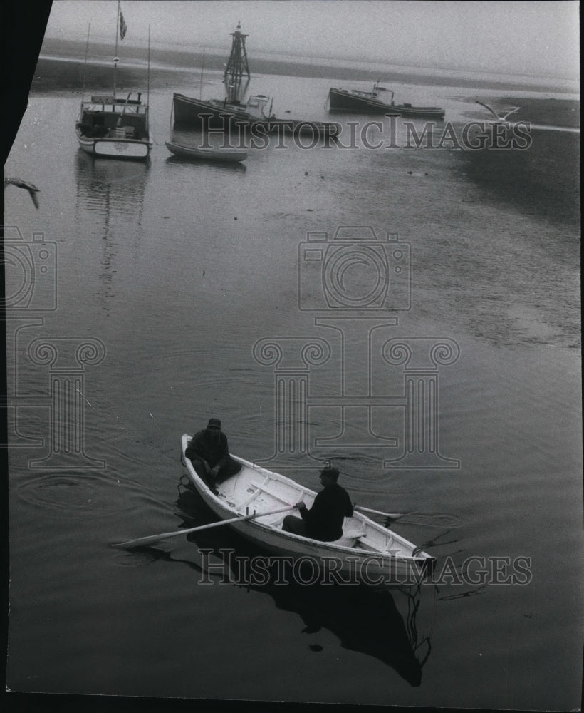 1966 Fishermen rowing ashore at end of day, Wedgeport, Nova Scotia - Historic Images