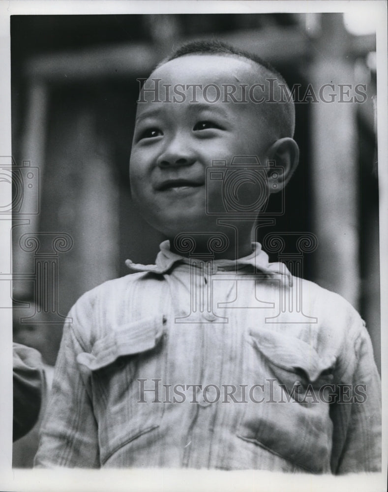 1959 Portrait of a smiling Chinese child in unknown location - Historic Images