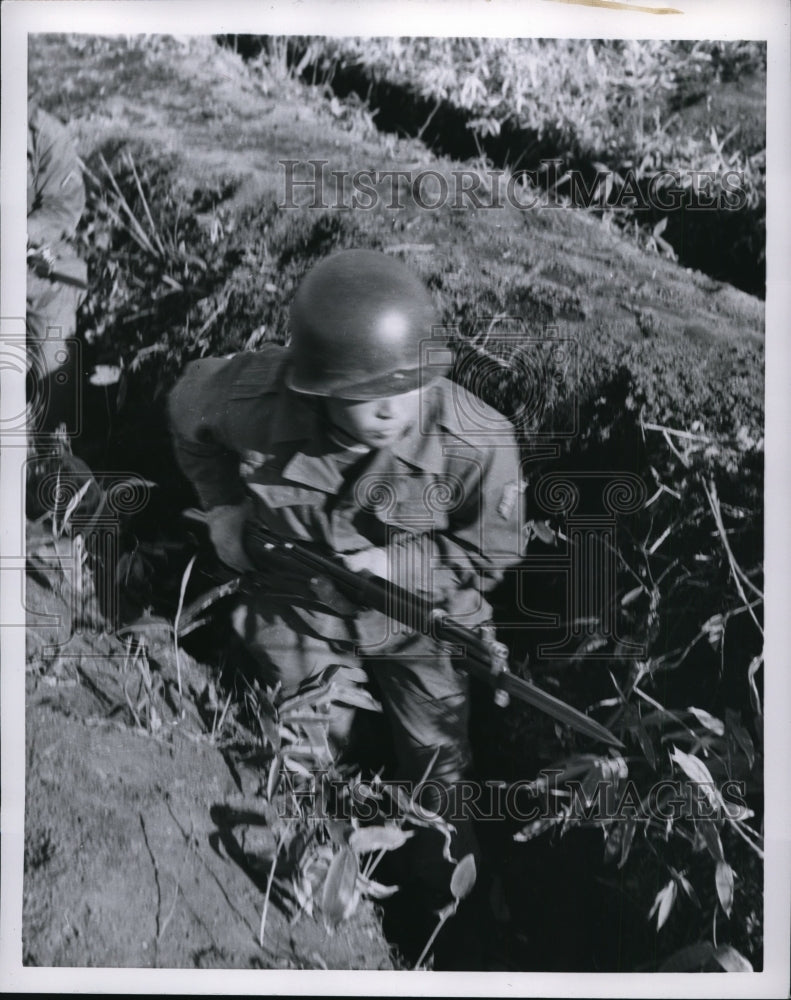 1955 Japanese soldier in a trench during a bayonet drill  - Historic Images