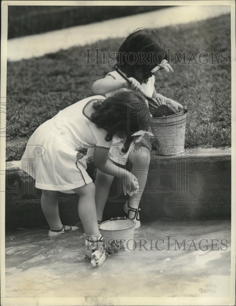 1937 Marie and Cecile play with sand  - Historic Images