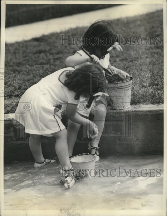 1937 Marie and Cecile play with sand  - Historic Images