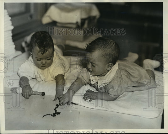 1935 Press Photo Cecile & Yvonne play with beads and a rattle - nera11661 - Historic Images