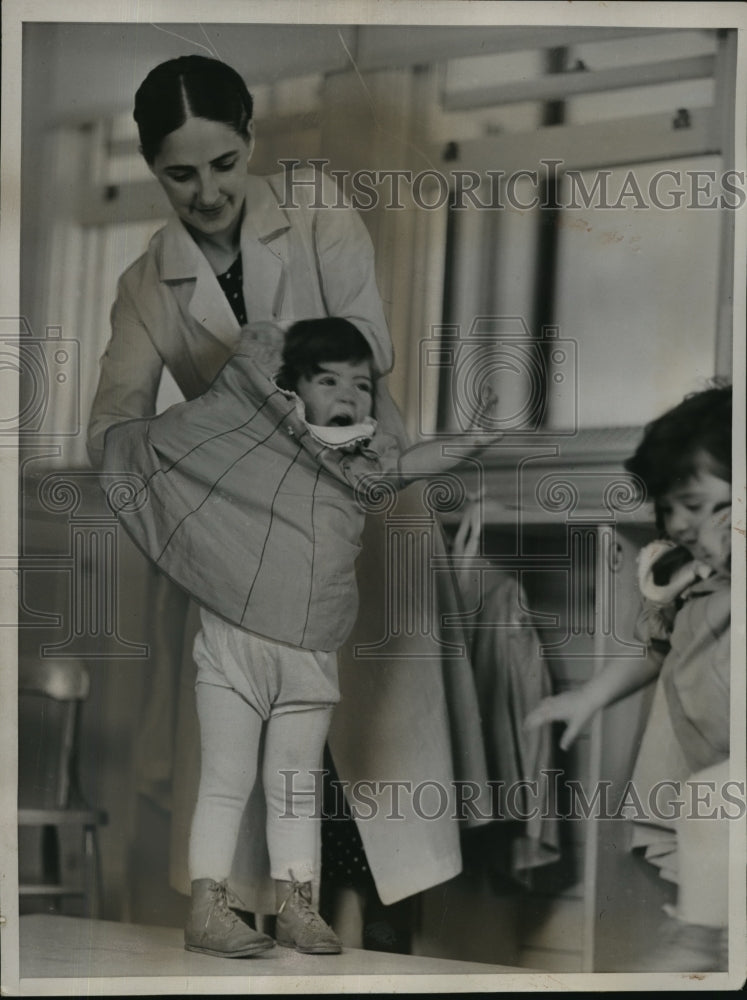 1937 Press Photo Nurse Noel dresses Marie - nera11826 - Historic Images