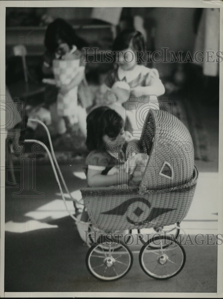 Press Photo Annette stows her baby away as they get ready for an airing-Historic Images