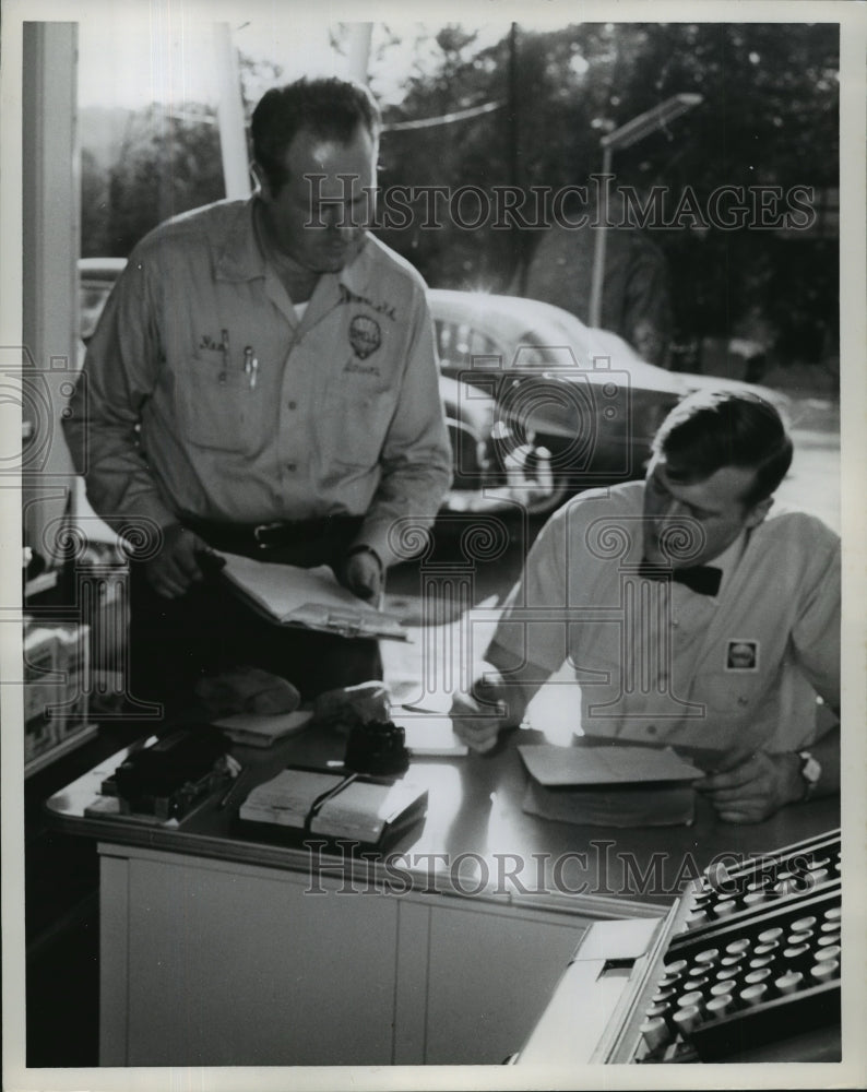 Auto attendants review paperwork  - Historic Images