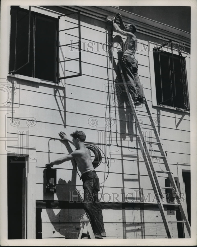 Press Photo Electricians install wiring on a home - nera12060 - Historic Images