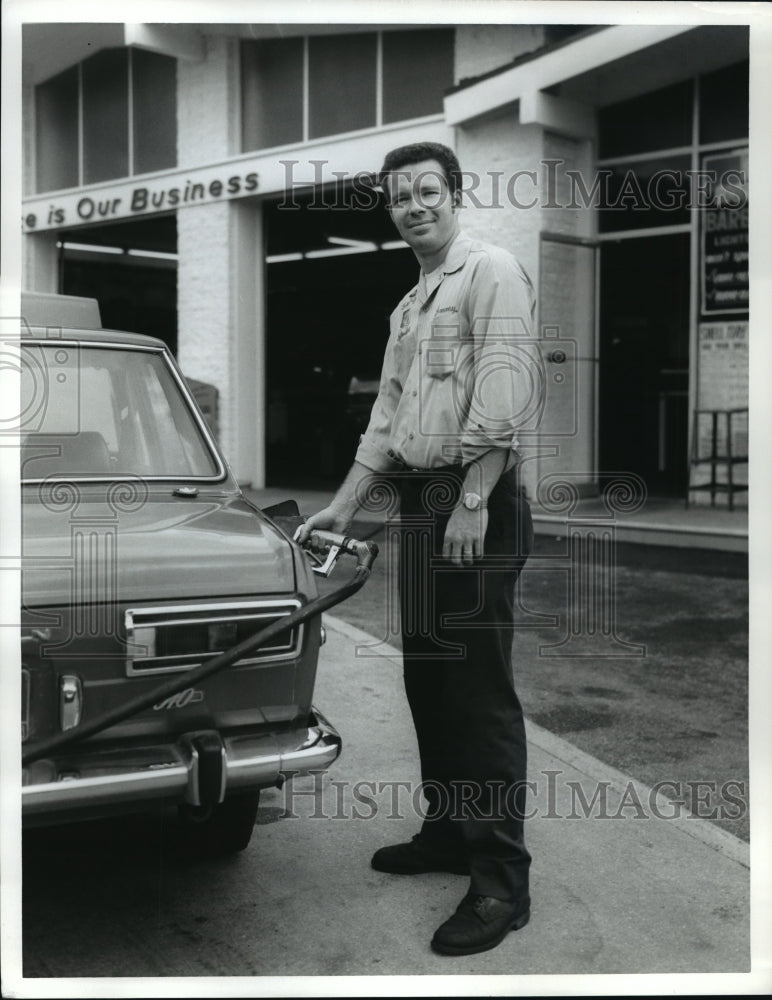 Press Photo Man puts gas in car, by Ewing Galloway - nera12149 - Historic Images