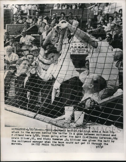 1956 Press Photo Youngster going after a ball when a foul tip stuck in screen. - Historic Images