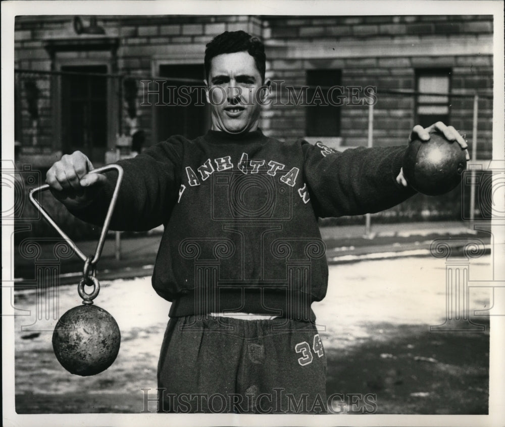 1951 Press Photo John Ogle holds 16-pound shot and 35-pound weight - nes24129 - Historic Images