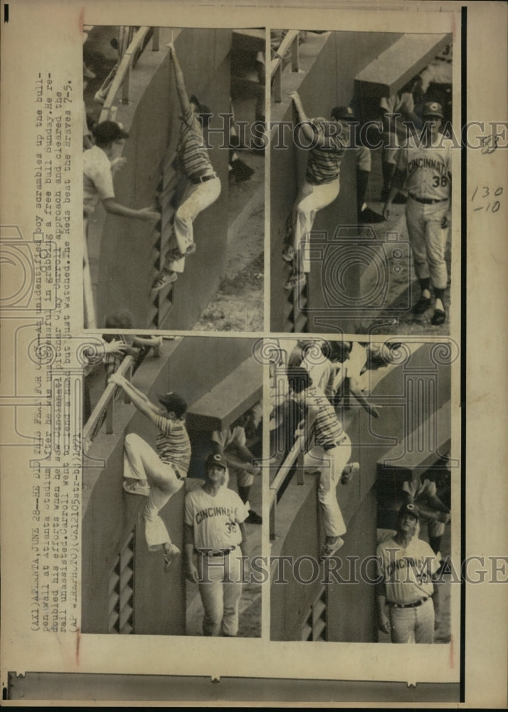 1971 Press Photo Boy climbs wall at Atlanta GA ball game with Reds Clay Carroll- Historic Images