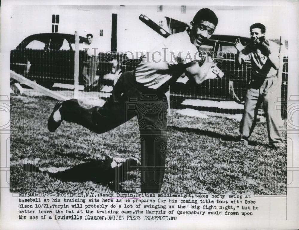 1953 Press Photo Boxer Randy Turpin swings at baseball while training for fight - Historic Images