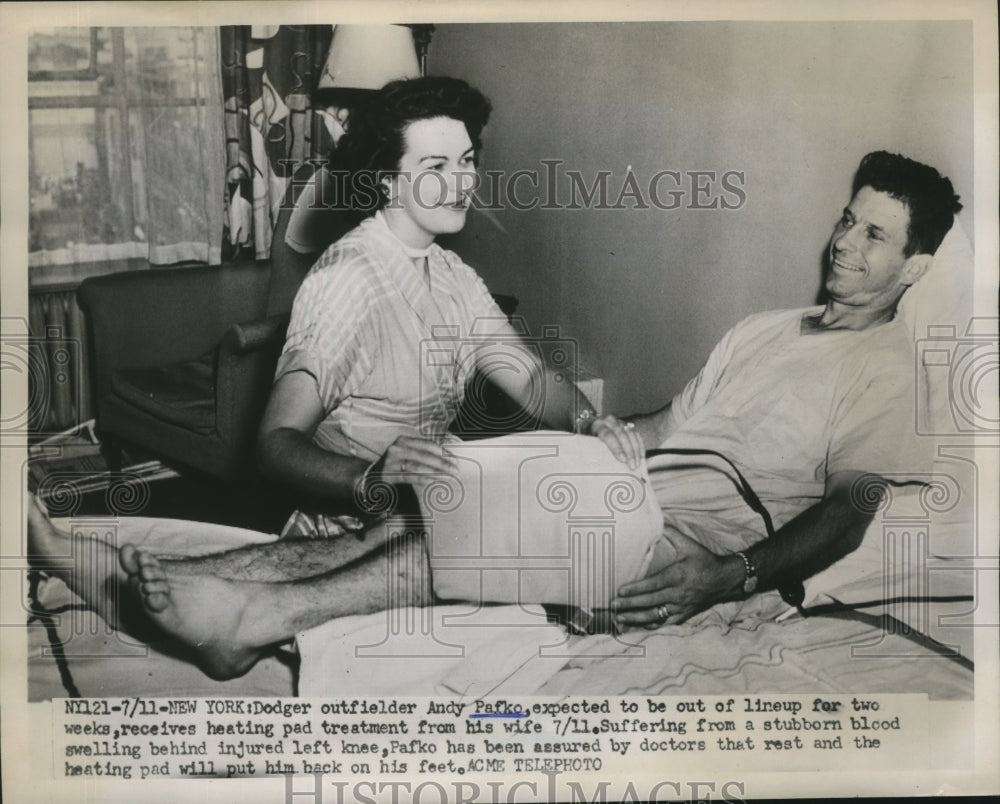 1951 Press Photo Dodgers outfielder Andy Pafko gets heating pad help from wife- Historic Images