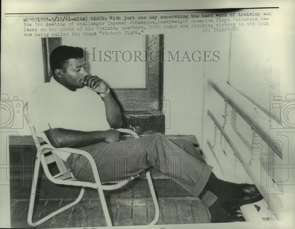 1961 Boxer Floyd Patterson relaxes at his training headquarters - Historic Images