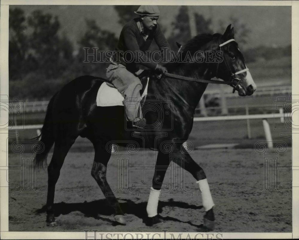 1937 Press Photo A exercise boy rides a racehorse in training at a track - Historic Images