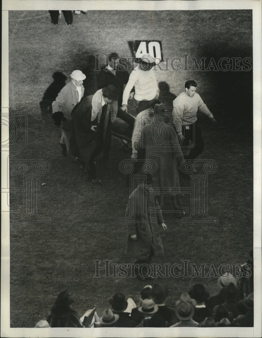1938 Press Photo Injured football player carried off the field on a stretcher - Historic Images