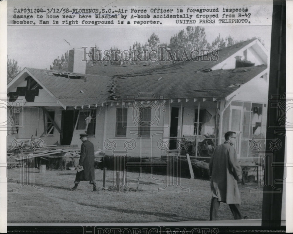 1958 Press Photo Air Force Officer inspect a home accidentally blasted by bomb. - Historic Images