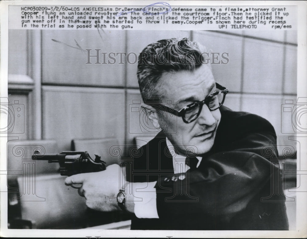 1960 Press Photo Grant Cooper during trial recess posing with gun - Historic Images