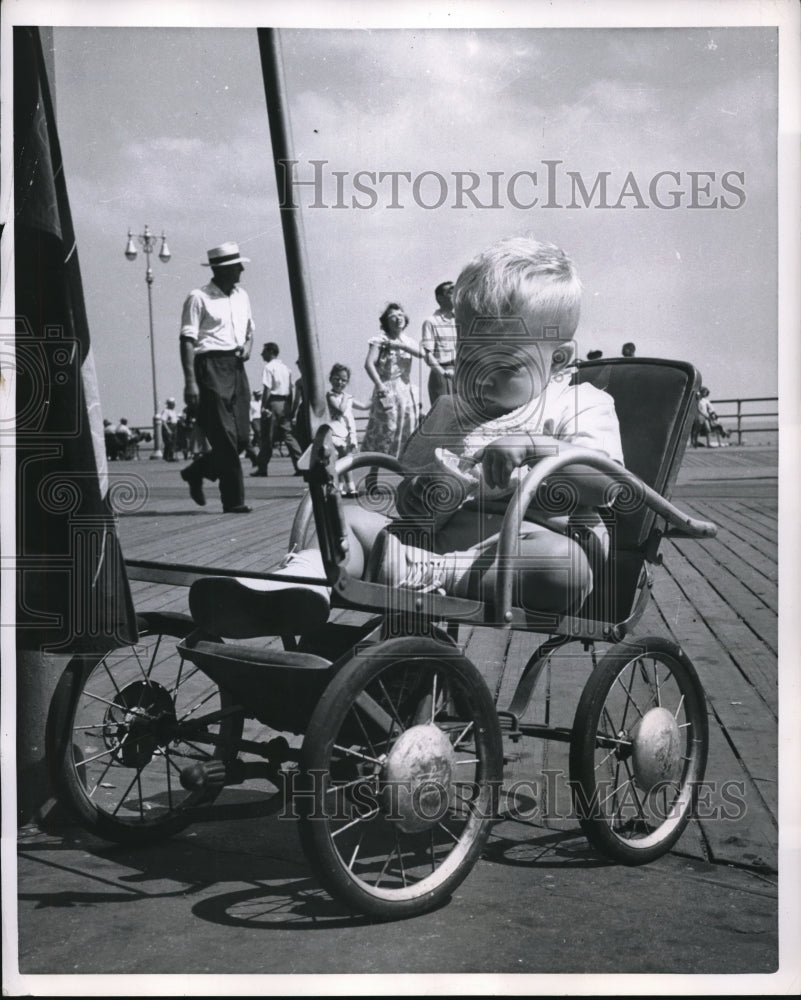 1952 Press Photo Baby Eating Ice Cream Cone with Hands, Sitting in Stroller - Historic Images