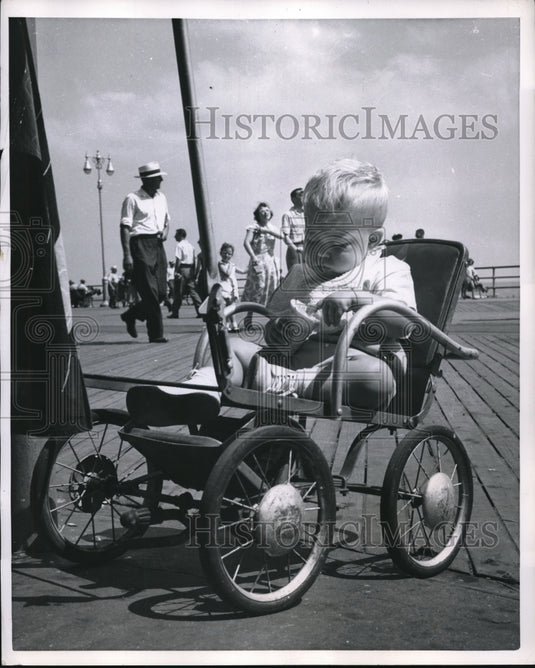 1952 Press Photo Baby Eating Ice Cream Cone with Hands, Sitting in Stroller - Historic Images