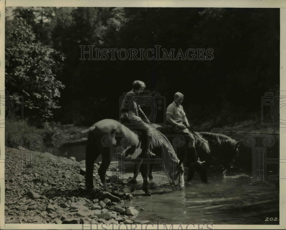 1930 Press Photo Forest Ranger &amp; Wife on Horseback at Stream - Historic Images