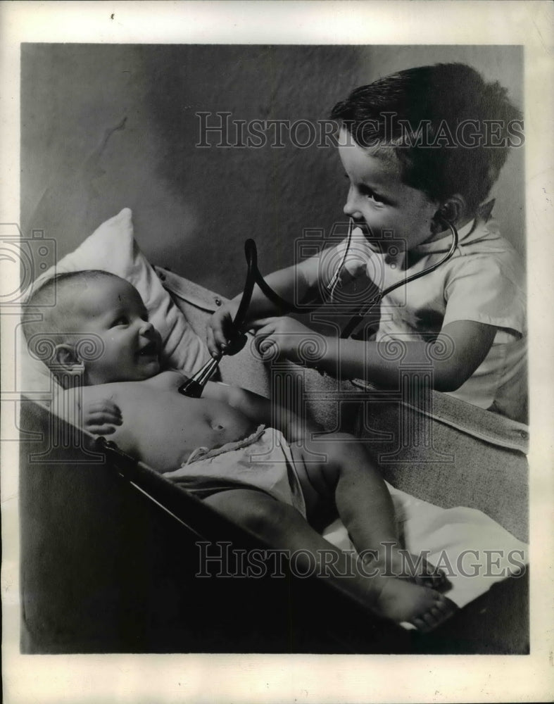 1944 Press Photo Boy Listens to Baby Heart with Stethoscope Photo by J Whiskeman - Historic Images