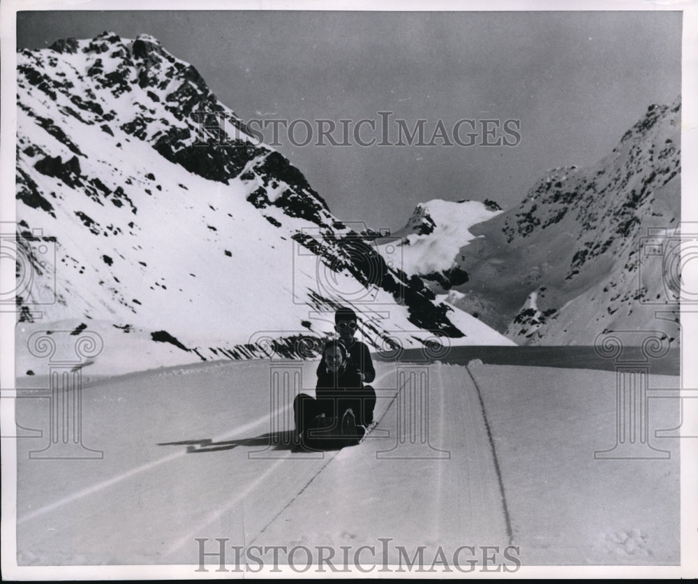 1954 Press Photo Kathryn  on a sled in snow in the mountains New Zealand - Historic Images