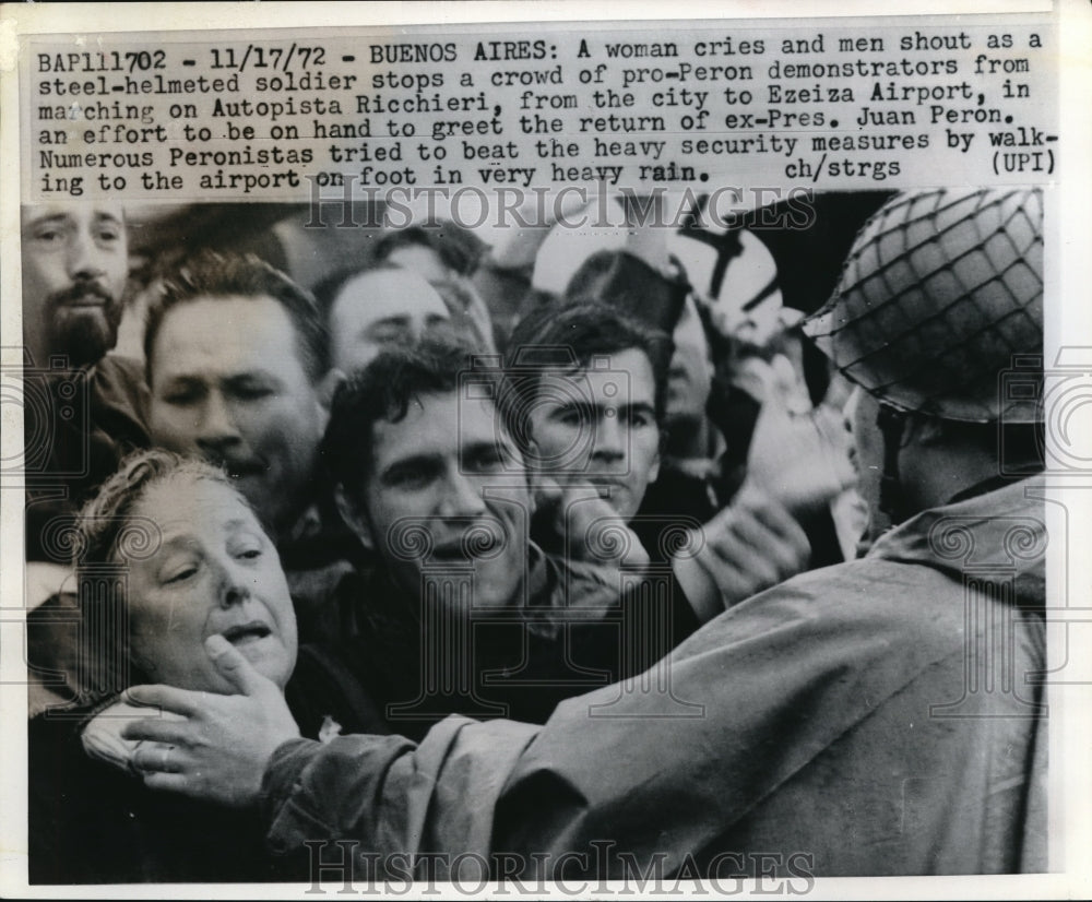 1972 Press Photo Soldier Restrains Pro Peron Demonstration in Argentina - Historic Images