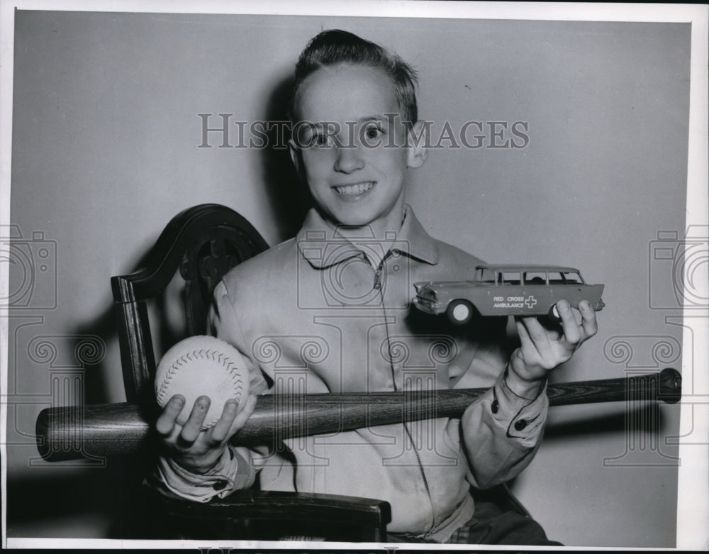 1957 Press Photo 12 Year Old Jimmy Thoma Saves Baby from Fall, Shows Reward Toys - Historic Images