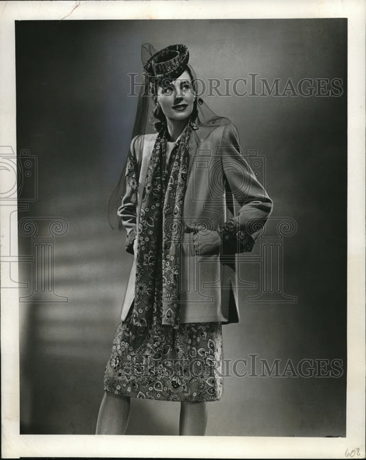 1944 Press Photo Indian print dress & golden wool coat modeled - Historic Images