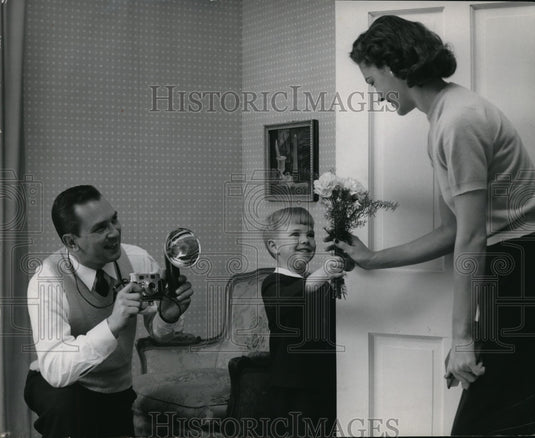 1956 Press Photo Son gives his mother a flower on Monday's Day - Historic Images