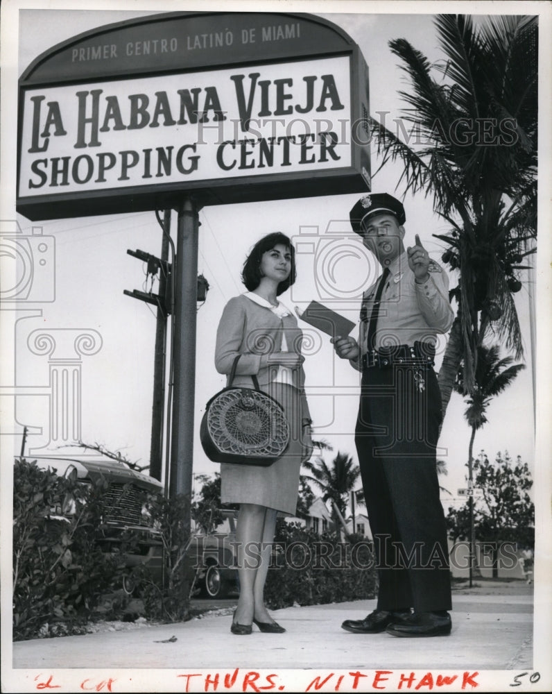 1966 Officer Robert Evans Directs Latin Visitor in Miami - Historic Images