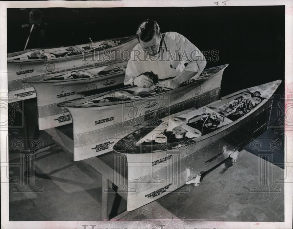 1951 John Heuss assembles fighter jet pylons for Westinghouse - Historic Images