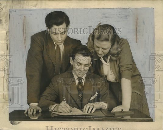 1943 Press Photo Jerry Berg, Madeline Cohein look over Larry Saltzman signature - Historic Images
