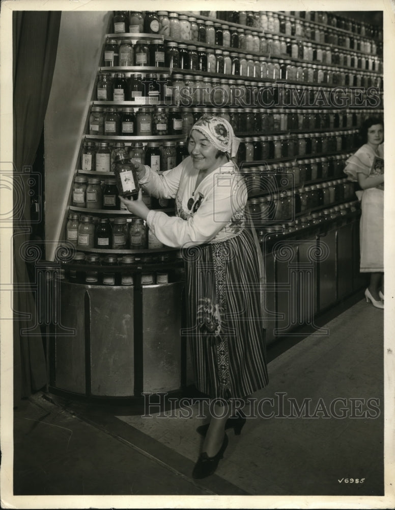 1933 Press Photo Estonian Woman Holding a Jar of Mushrooms at Exhibition Show - Historic Images