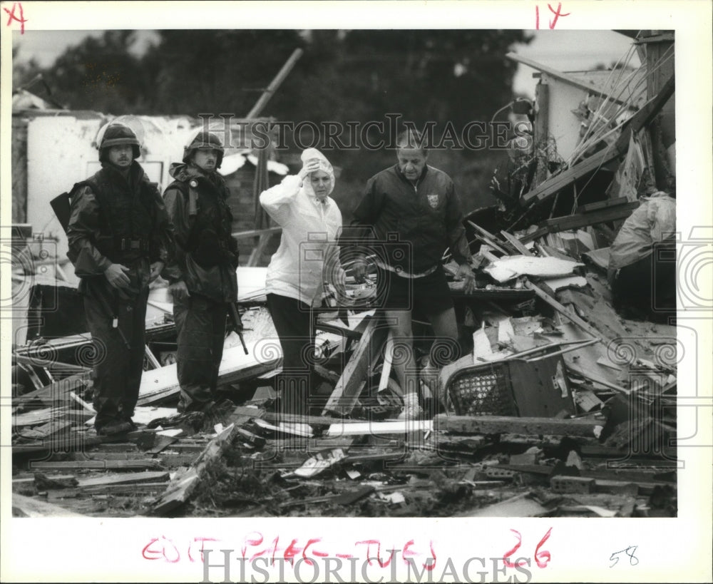 1992 Hurricane Andrew - National Guards watch residents comb debris. - Historic Images