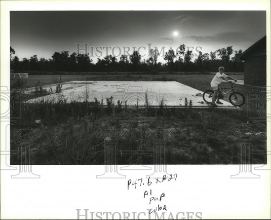 1993 Boy Rides Bike Over Slab Of Home Destroyed By Hurricane Andrew - Historic Images