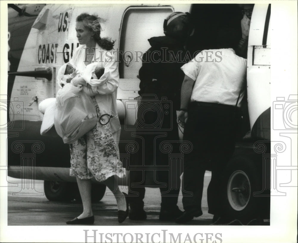 1992 Hurricane Andrew - Cathy Osterich gets off Coast Guard chopper. - Historic Images