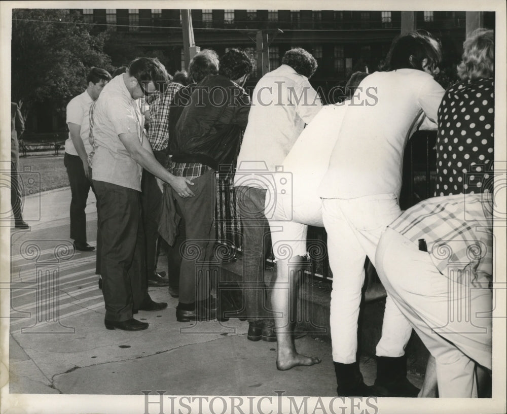 1967 Men Line Up to be frisked on Jackson Square in New Orleans - Historic Images