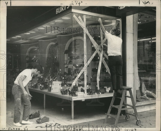 1969 Men Tape up Windows Before Hurricane Camille Hits  - Historic Images