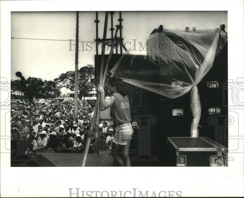 1988 Soundman Covers Gear as it Begins to Rain, Jazz Fest - Historic Images